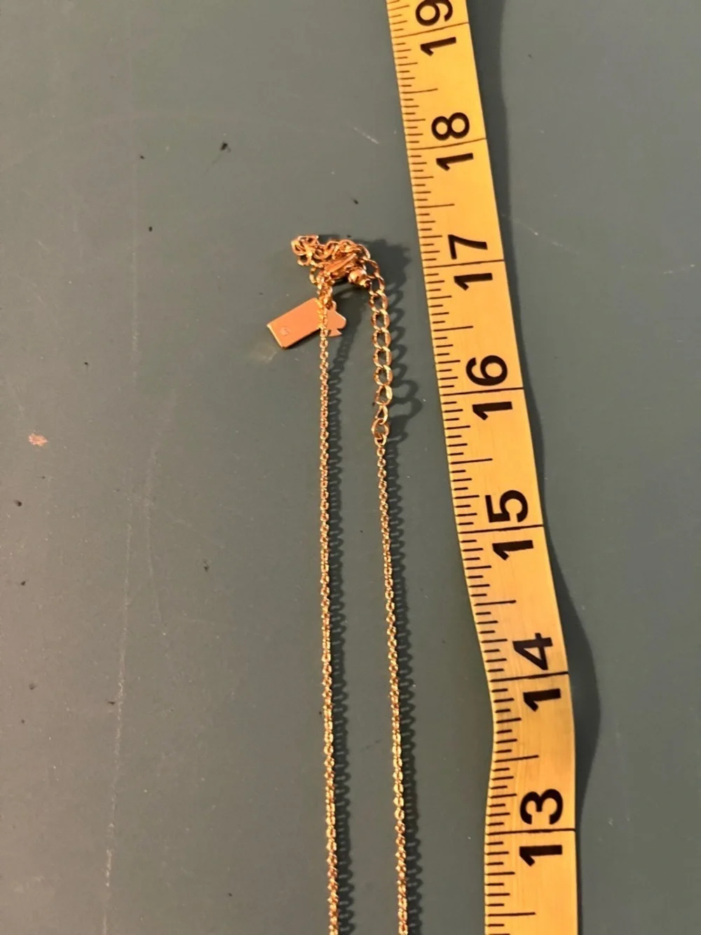 Kate Spade long golden necklace with crystal beads.